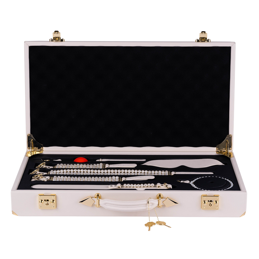 The white PEARL case open, six ivory pieces and pearl strands in a black tray