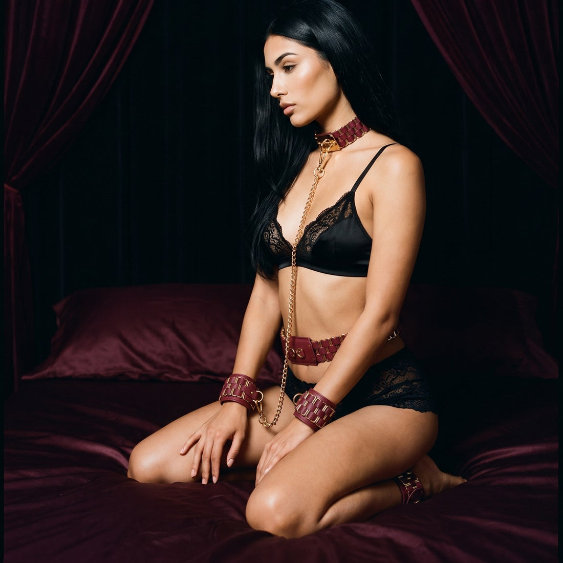 The red KEEN collar and belt and wrist and ankle cuffs worn kneeling